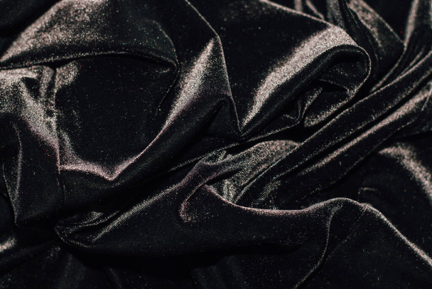 Texture of black velor corduroy fabric with folds. - Zdjęcie, obraz