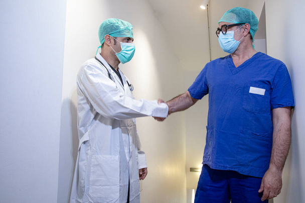 portrait of two confident doctors wearing protective masks - Photo, Image