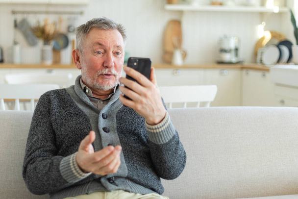 Щасливий старший чоловік середнього віку розмовляє про відеодзвінки з родиною друзів. Сміючись дорослим старим старшим дідом, весело розмовляти з дорослими дітьми онлайн. Сучасне використання технологій старого покоління
 - Фото, зображення