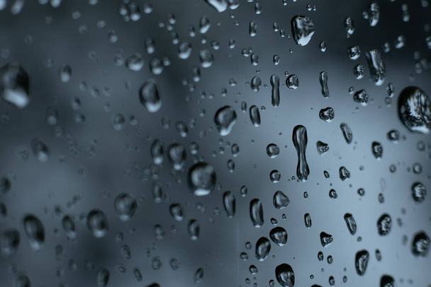 Σταγόνες νερού στο γυαλί. Σταγόνες βροχής στο γυαλί του αυτοκινήτου. Καταιγίδα Κλιματική βροχή σε γυαλί παράθυρο - Φωτογραφία, εικόνα