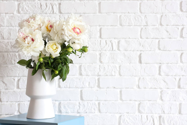 Vase of white peonies near brick wall - Φωτογραφία, εικόνα