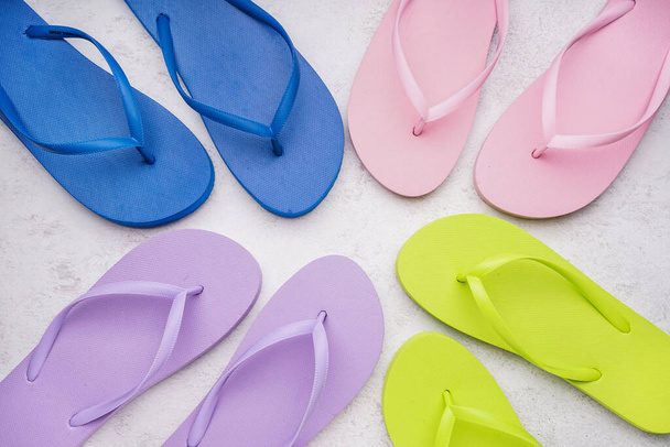 Different color flip-flops on white grunge background - Foto, immagini