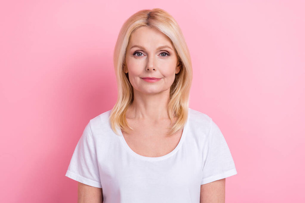 Portrait of gorgeous middle age lady wearing white default t-shirt posing for makeup magazine advert isolated on pink color background. - Foto, Bild