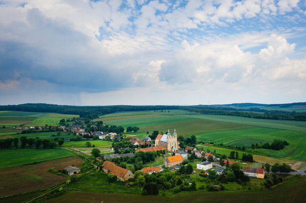 Bobolice, uitzicht vanuit de lucht op het Poolse dorp en het heiligdom van Lady of Bobolica, Neder-Silezisch landschap. Drone uitzicht op prachtige, landelijke landschap met kerk. - Foto, afbeelding