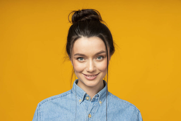 Young woman in a denim shirt, hair tied up - Foto, Imagem