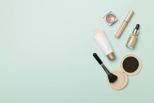 Makeup products for skin tone on color background, top view. - 写真・画像