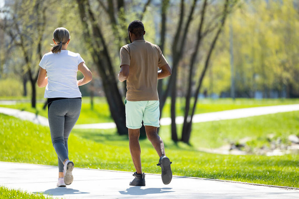 Healthy lifestyle. Mature couple jogging in the park in the morning - Foto, immagini