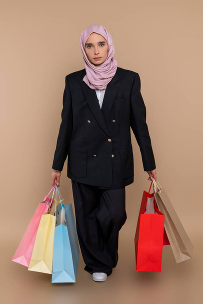 After shopping. Young muslim elegant woman with shopping bags looking contented - Foto, Imagem