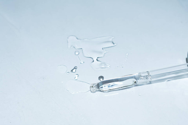 Syringe and drop of liquid on a white background close-up - Photo, Image