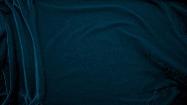 背景にブルーベルベット生地のテクスチャ。柔らかく滑らかな繊維素材の孔雀色のパンヌ生地の背景。砕いたベルベット絹のための豪華な海軍のトーン. - 写真・画像