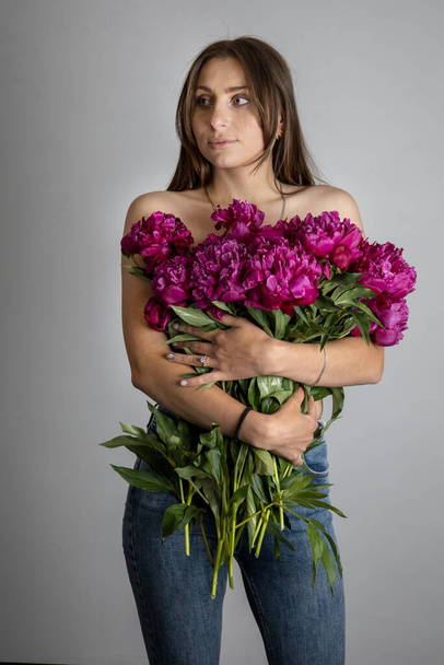 beautiful young girl with flowers. - Фото, изображение