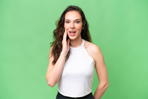 Young caucasian woman isolated over isolated background with surprise and shocked facial expression - Photo, Image