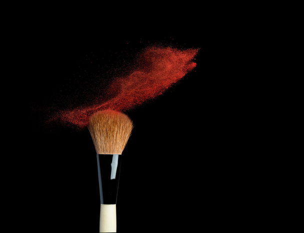 powderbrush on black background with blue powder splash - Fotó, kép