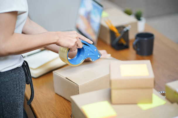 Business From Home Asian woman preparing package delivery box Shipping for shopping online. young start up small business owner at home online order. - Foto, imagen