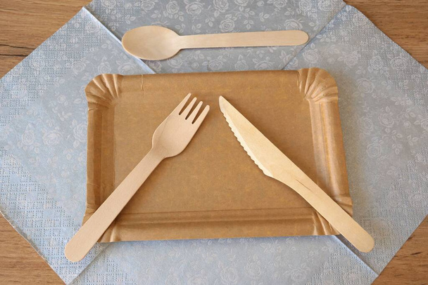 Recyclable picnic wooden cutlery, paper plates and copper drinking straws. - Fotó, kép