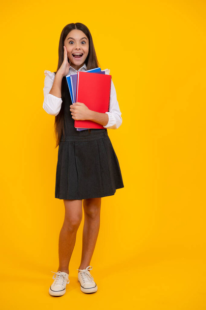 Amazed teen girl. Teenage school girl with books. Schoolgirl student. Excited expression, cheerful and glad - Photo, image