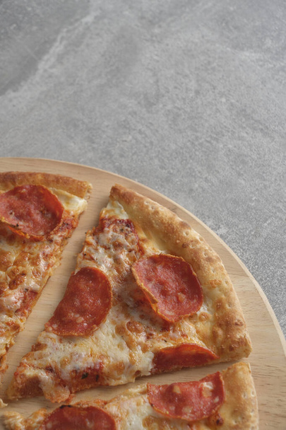 Pepperoni pizza with sausage gray concrete background - Foto, imagen