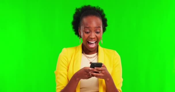 Phone, money rain and woman on green screen, wow and winning in lottery, online gambling or competition. Cash in air, financial freedom and african person success, yes and mobile on studio background. - Felvétel, videó