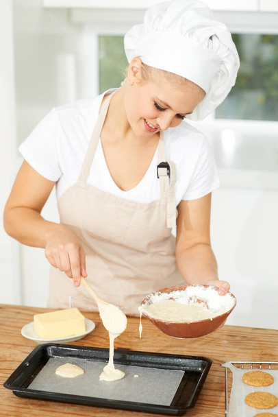 Happy woman, bakery or chef baking cookies with dough or pastry in a kitchen and is happy decorating his recipe. Food business, dessert or girl baker working in preparation of a sweet meal or biscuit. - Fotoğraf, Görsel
