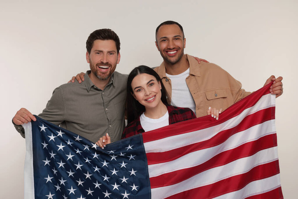 4th of July - Independence Day of USA. Happy friends with American flag on white background - Photo, Image