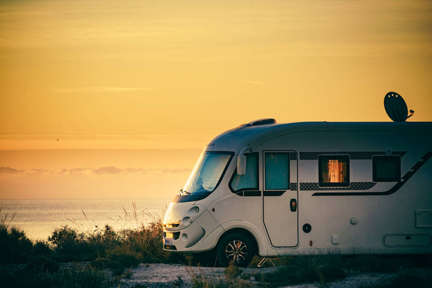 Camper rv camping on seacoast nature in the morning at sunrise. Holidays in Spain, travel with motor home. - Foto, immagini