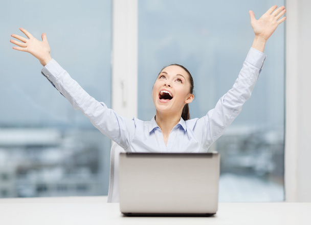 screaming businesswoman with laptop in office - 写真・画像