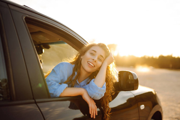 Towards adventure! Young woman is resting and enjoying the trip in the car. Lifestyle, travel, tourism, nature, active life. - Fotoğraf, Görsel