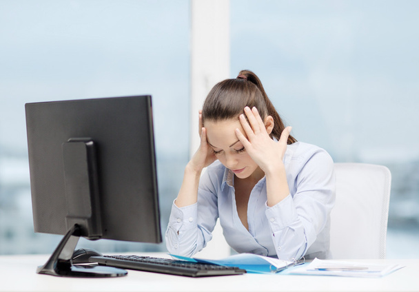 stressed woman with computer and documents - Φωτογραφία, εικόνα