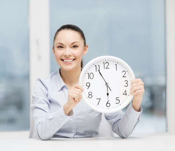 attractive businesswoman with white clock - Фото, изображение