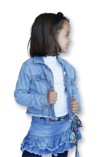 Child in jeans and white background posing for photos. - Foto, immagini
