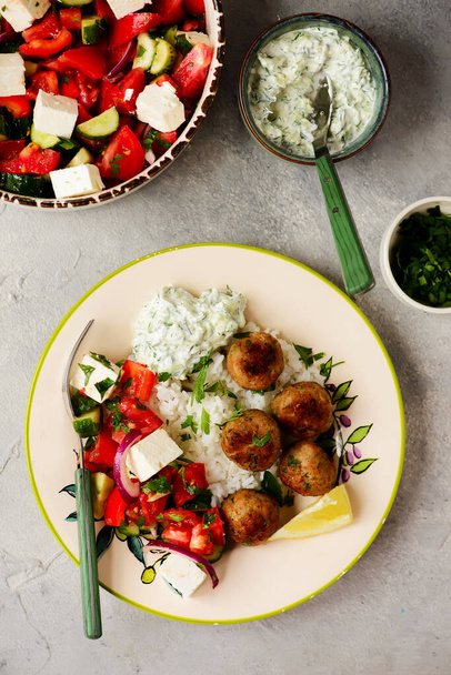 Greek style meatboll with rice and salad  and tzatziki.selective focus - Foto, immagini