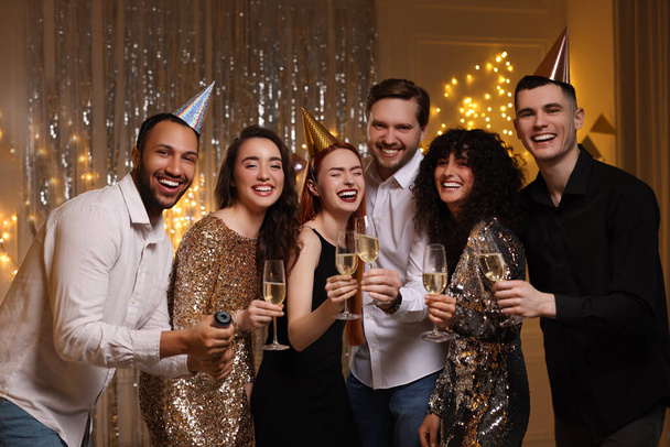 Happy friends with glasses of sparkling wine celebrating birthday indoors - Foto, Imagem