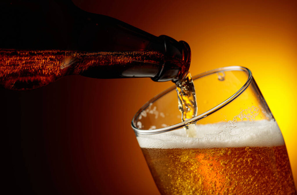 Pouring beer from a bottle into a glass. Copy space. - 写真・画像