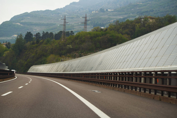 Солнечное шоссе это шумовой барьер вдоль автомагистрали. Солнечные модули вдоль автомагистралей в Европе. Концепция устойчивого будущего. - Фото, изображение