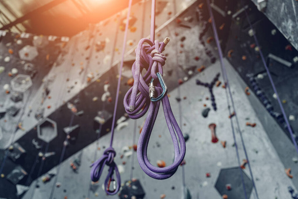 Artificial climbing wall with colorful grips and ropes. - Fotografie, Obrázek
