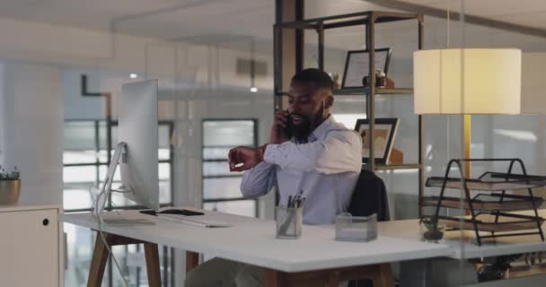 Late, work and a black man on a phone call in an office ready to leave in the evening. Happy, company and an African manager checking the time on a watch while talking on a mobile and leaving desk. - Felvétel, videó