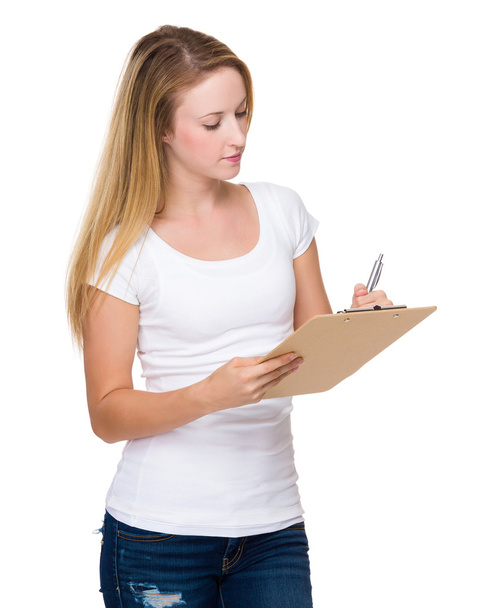 Woman writes on clipboard - Photo, image