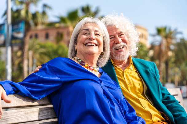 Senior couple of old people dating outdoors - Married elderly man and woman in love spending time together - Grandparents having fun strolling in the city - Photo, Image