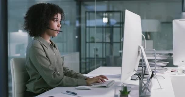 Phone call with woman at help desk, typing on computer and smile, agent working at customer service agency. Happiness, telemarketing and virtual assistant at callcenter with advisory work in office - Footage, Video
