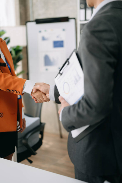 Two confident businesspeople shaking hands during a meeting in the office, success, dealing, greeting and partner - 写真・画像