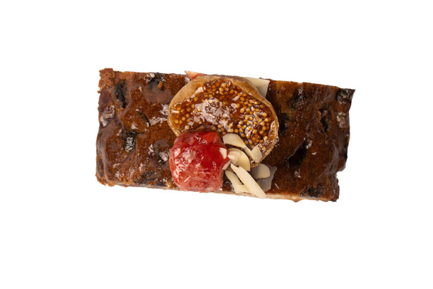 A cake with dried fruits, raisins almonds, dried strawberry, dried apricots. - Photo, Image