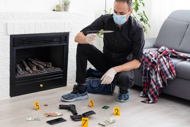 Detective Collecting Evidence in a Crime Scene. Forensic Specialists Making Expertise at Home of a Dead Person. Homicide Investigation by Professional Police Officer. High quality photo - Photo, Image
