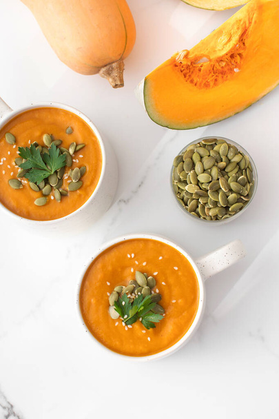 Mugs of warm pumpkin soup. The concept of the autumn menu, easy vegetable recipes. Autumn recipes. - Fotó, kép