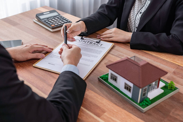 Buyer sign house loan contract with satisfaction after agree to term and condition of house loan with real estate agent. Contract document with clients signature as housing business concept. Jubilant - 写真・画像