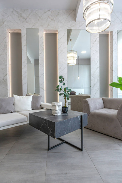 stylish bright modern bedroom interior with decorative niches with LED lighting and a huge panoramic window in gray and white colors and geometric shapes - Φωτογραφία, εικόνα
