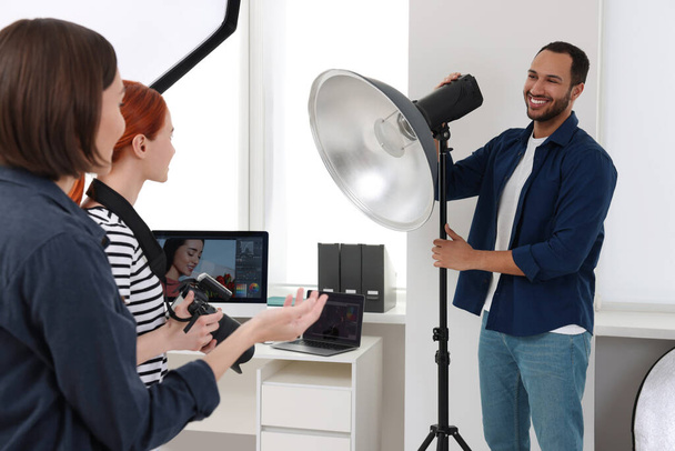 Young professional photographers working in modern photo studio - Fotoğraf, Görsel