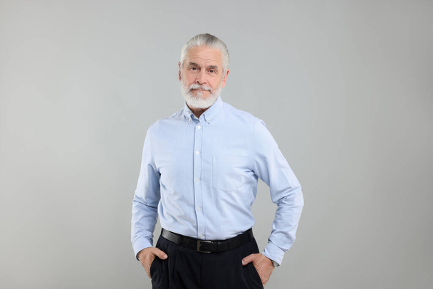 Portrait of handsome senior man on light grey background - Fotó, kép