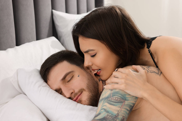 Passionate young couple having sex on bed - Fotó, kép