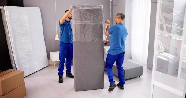 Professional Furniture Movers Wrapping. House Packing Service - Photo, image