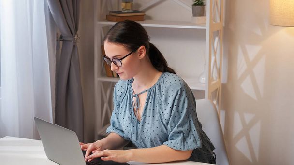 Remote job. Internet research. Online management. Smart busy woman employee working from home using laptop at modern workplace interior with free space. - Φωτογραφία, εικόνα